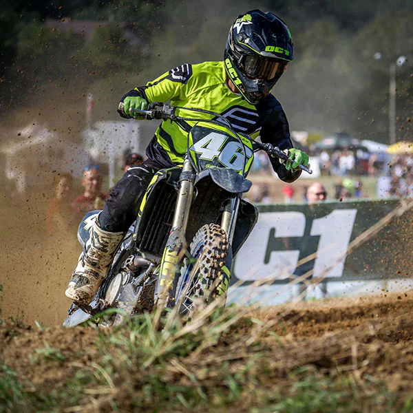 Motocross rider in OC1 gear cornering on a dirt track