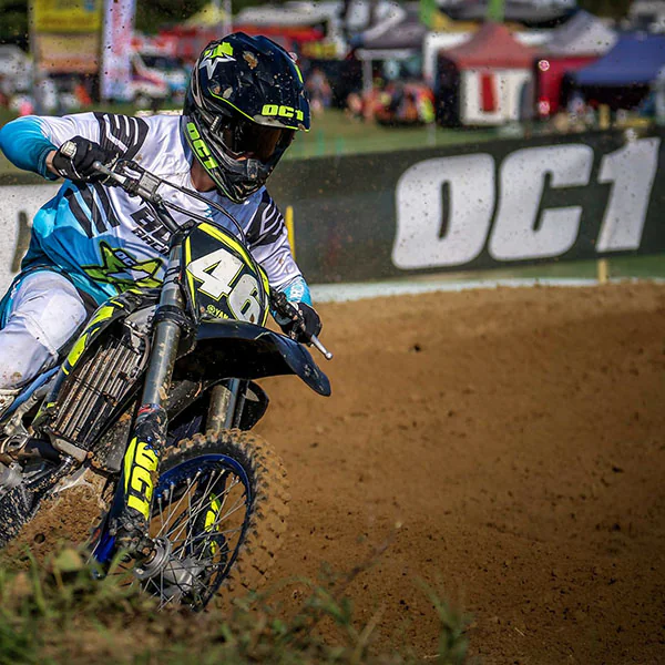 Motocross rider cornering past an OC1 board
