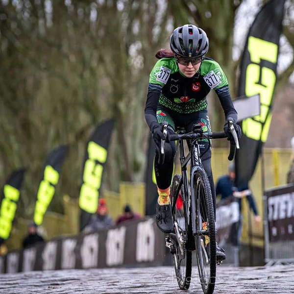 Cyclocross race on wet cobbles past OC1 flags